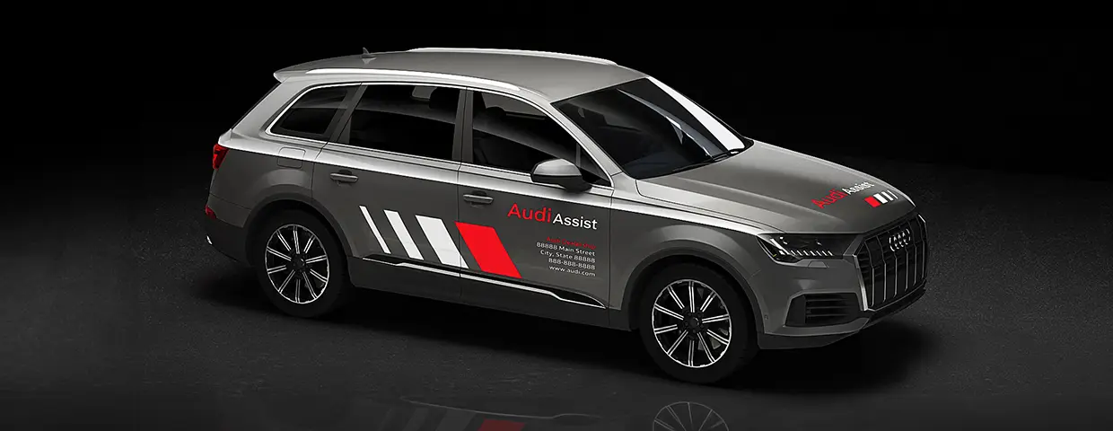 A three-quarter view of an Audi SUV with CG Detroit created Audi Assist vehicle graphics installed on the hood and side doors.