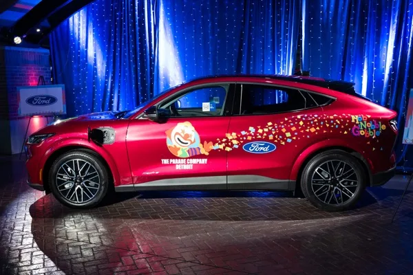 A Ford vehicle wrapped for The Parade Company on a lit display stage