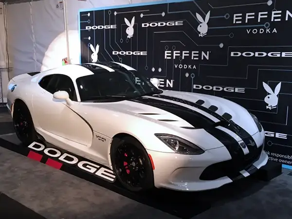 A race car display featuring a Dodge Viper race car with custom motorsports graphics and signage created by CG Detroit.