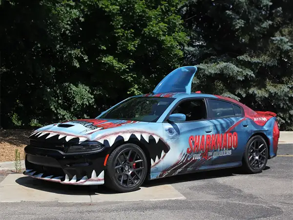 A Dodge Charger race car with custom Sharknado motorsports wrap designed, produced and installed by CG Detroit.